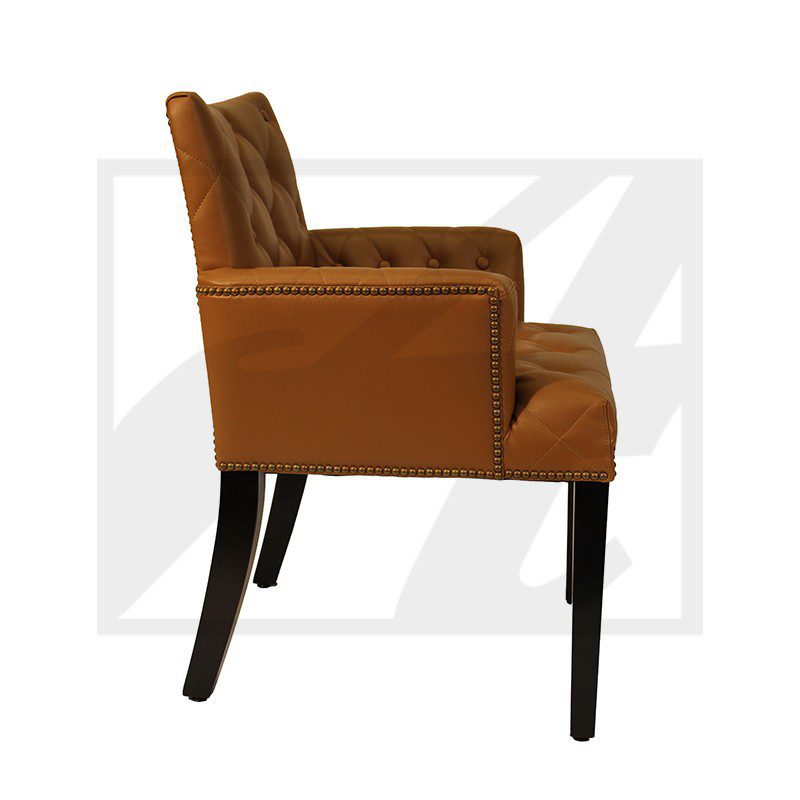 Side view of a brown upholstered armchair with black wooden legs.