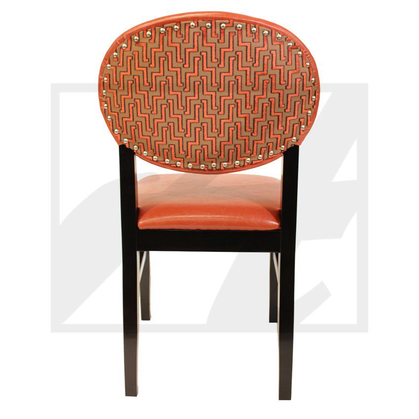 Wooden chair with woven backrest and orange cushion.