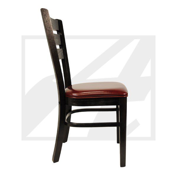 Side view of a wooden chair with a cushioned red seat.