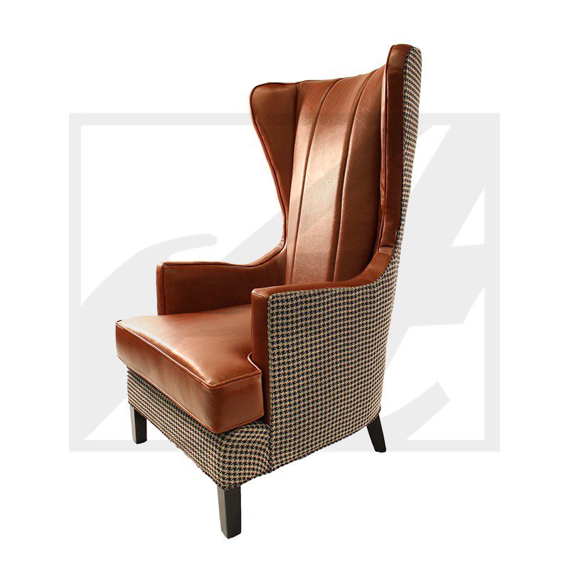 Elegant brown leather wingback chair with woven sides and dark wooden legs.