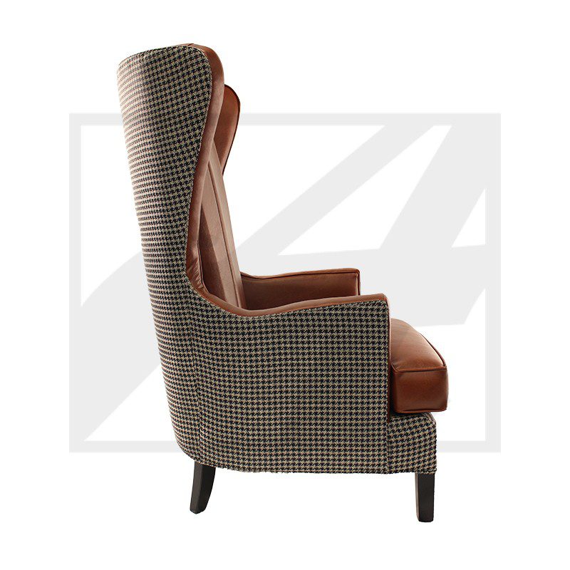 Side view of a stylish wingback armchair with patterned upholstery and brown cushions.