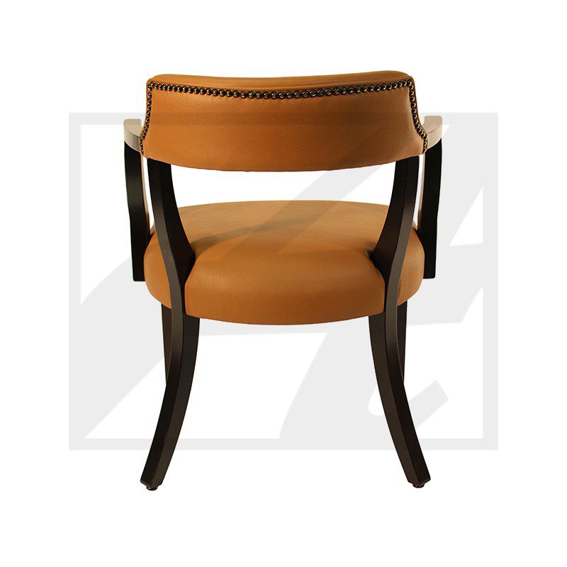 Modern chair with curved wooden frame and tan upholstery.