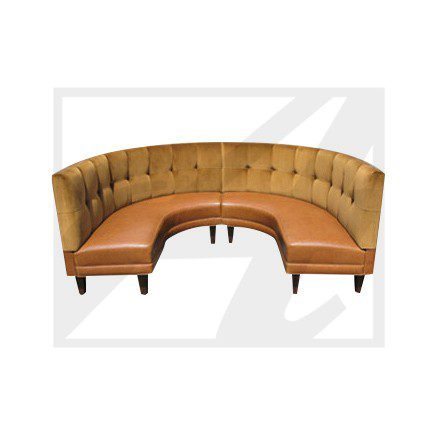 Curved brown leather and fabric sectional sofa with button tufting.