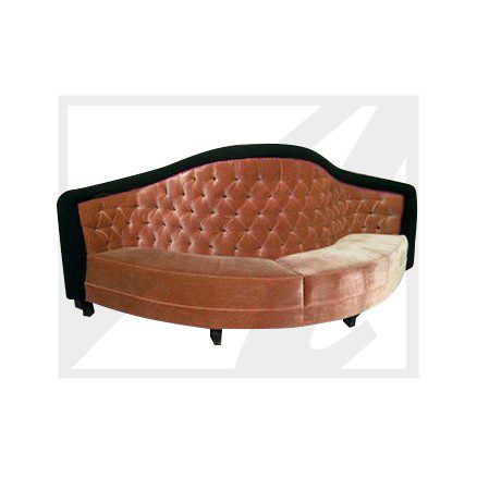 Elegant velvet tufted sofa with a curved design and black wooden frame.