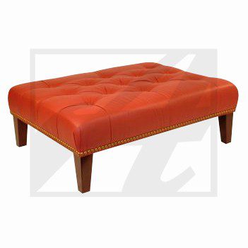 Red rectangular ottoman with wooden legs.
