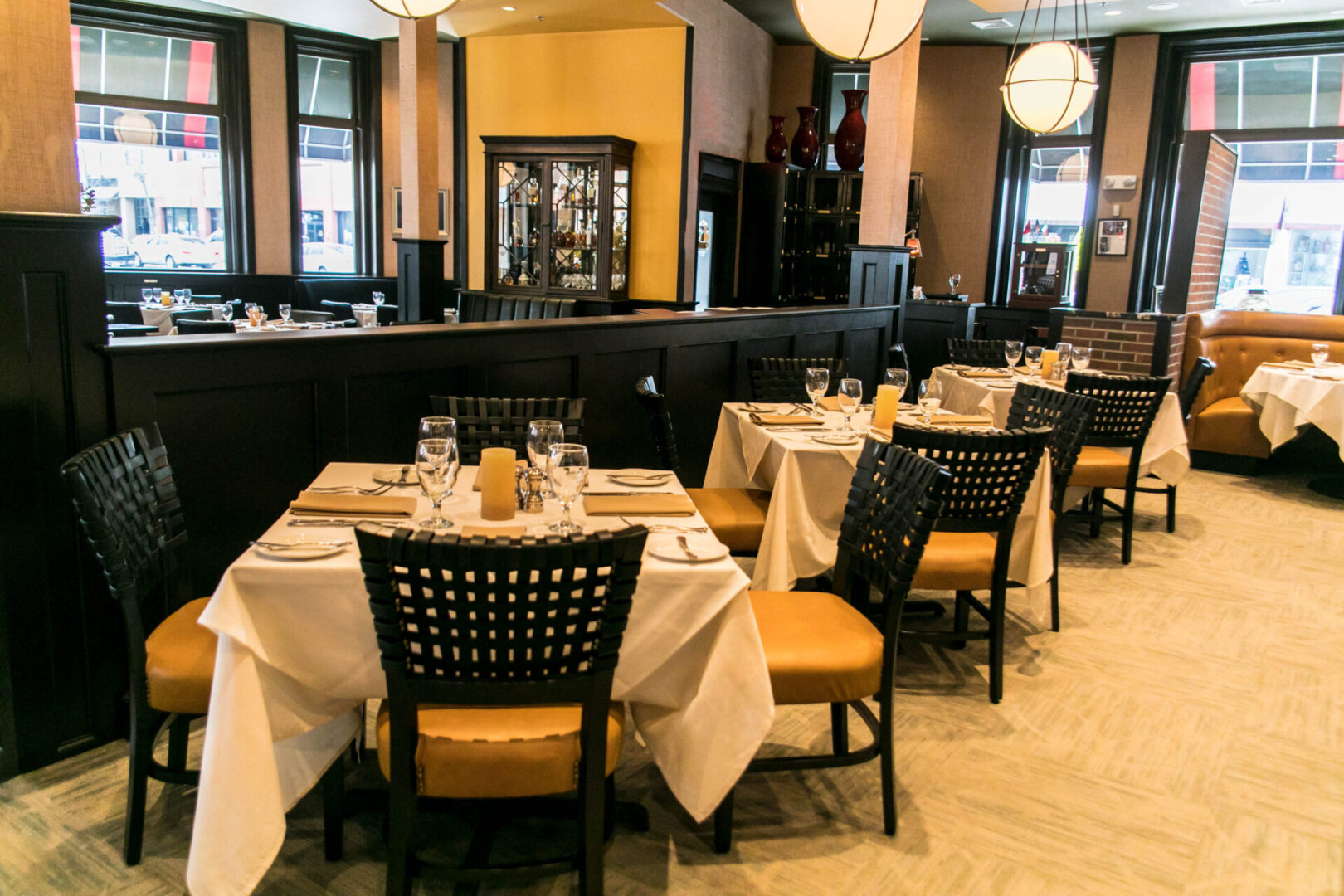 Elegant restaurant dining area with neatly set tables and warm lighting.