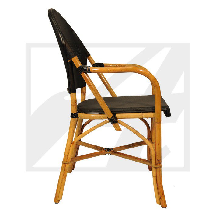 Side view of a rattan and black fabric chair with a natural finish.