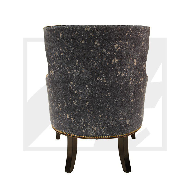 Rear view of a dark upholstered armchair with wooden legs.