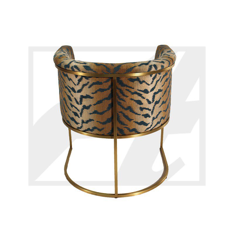 Elegant tiger-print chair with gold metal frame and curved design.