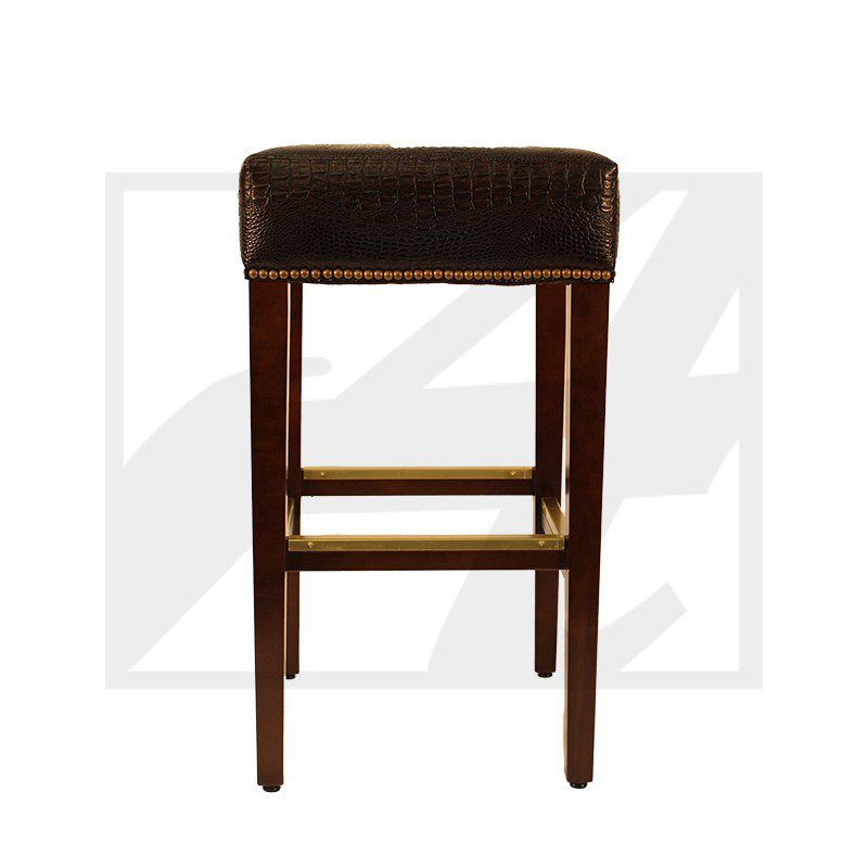 A wooden bar stool with a dark cushioned seat and footrest.