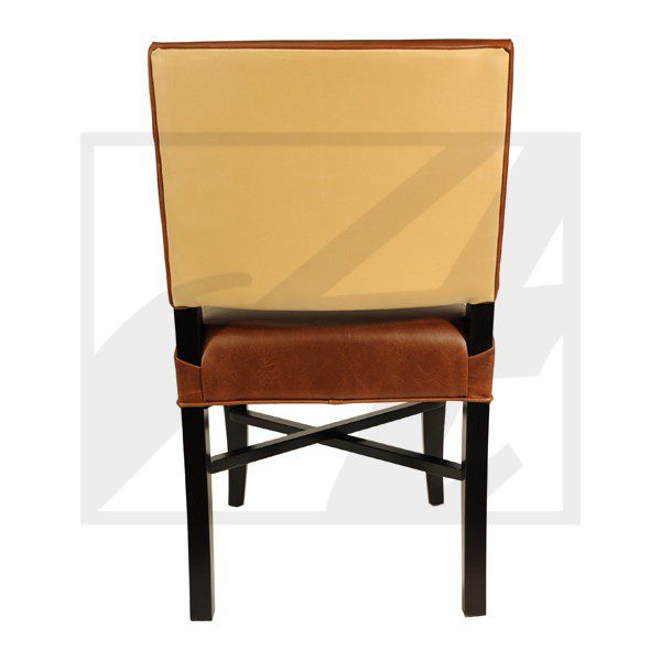 A wooden chair with a tan cushioned backrest and seat viewed from behind.