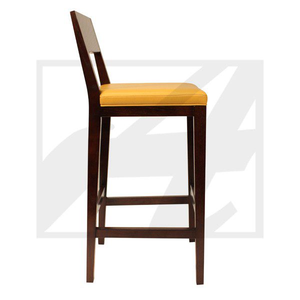 Side view of a wooden bar stool with a yellow cushion.